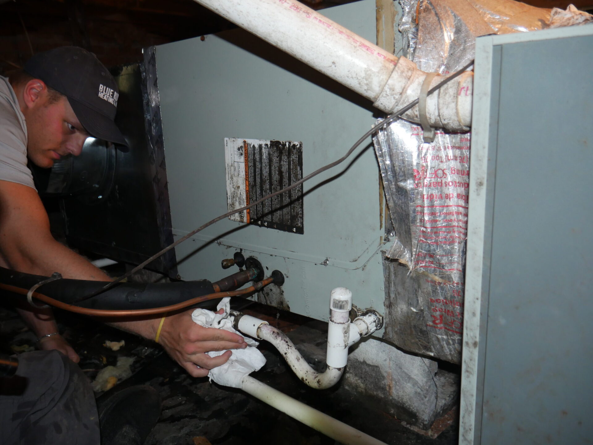 Noah cleaning an HVAC unit